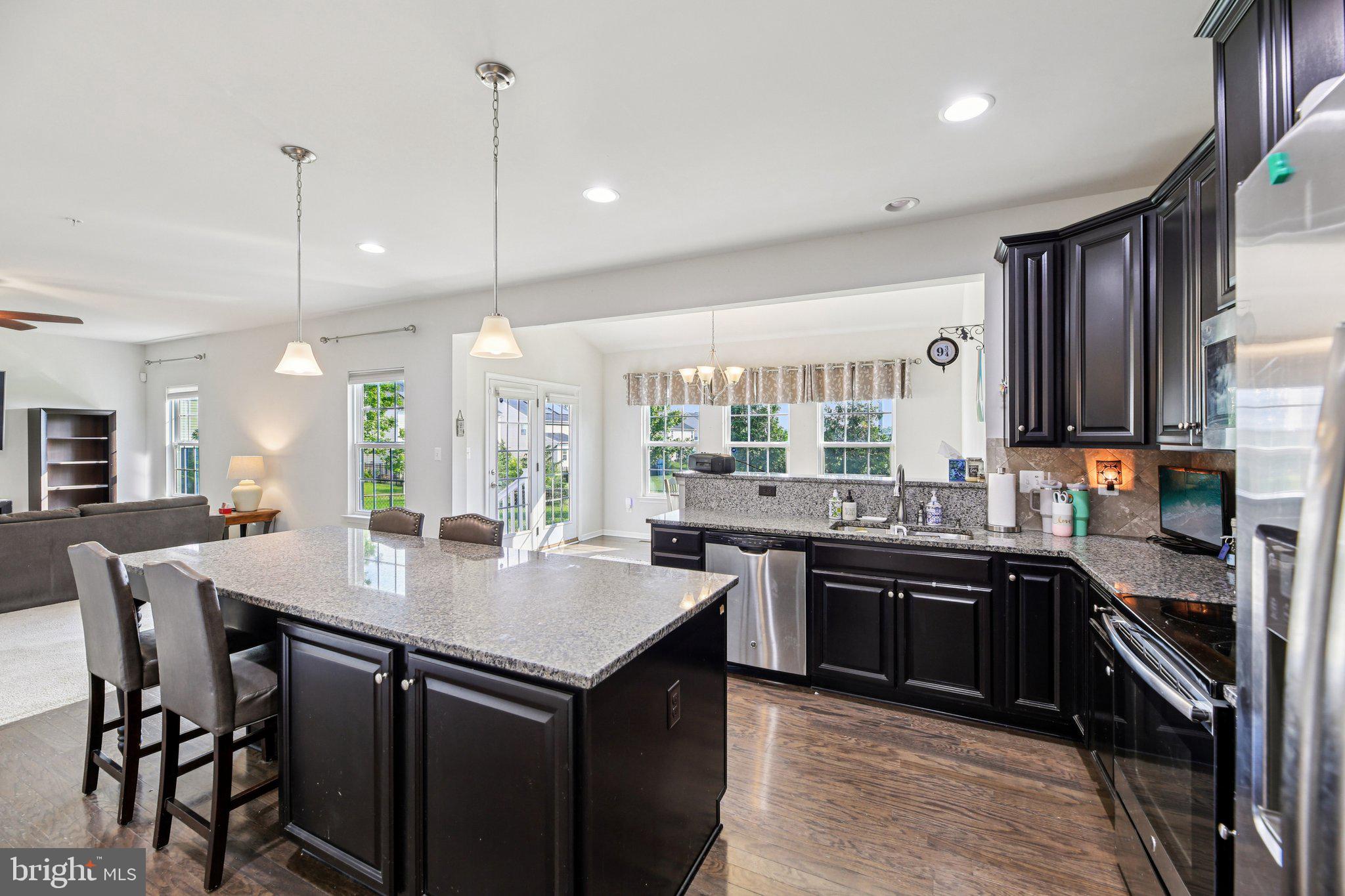 5733 Allender Road White Marsh, MD 21162 - Photo 13 of 47 a kitchen with granite countertop a sink stove and cabinets