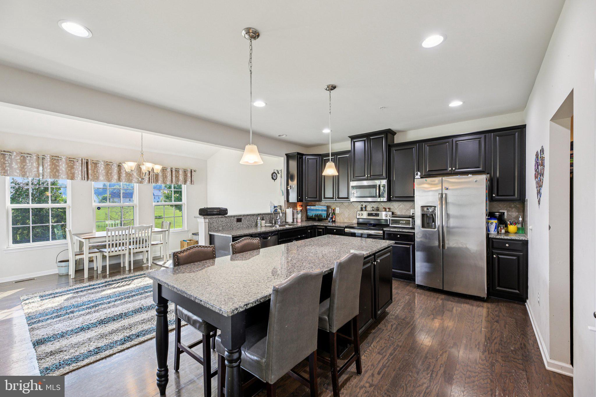 5733 Allender Road White Marsh, MD 21162 - Photo 14 of 47 a kitchen with refrigerator cabinets and wooden floor