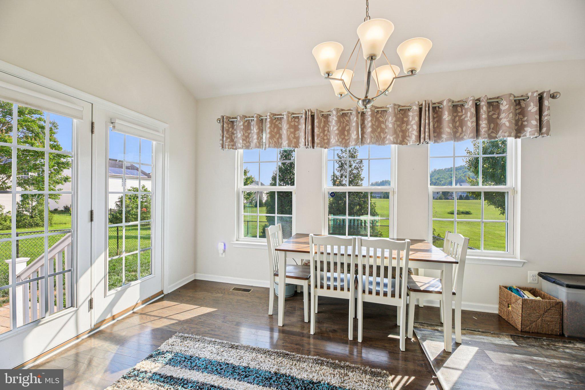 5733 Allender Road White Marsh, MD 21162 - Photo 15 of 47 a dining room with wooden floor and a large window
