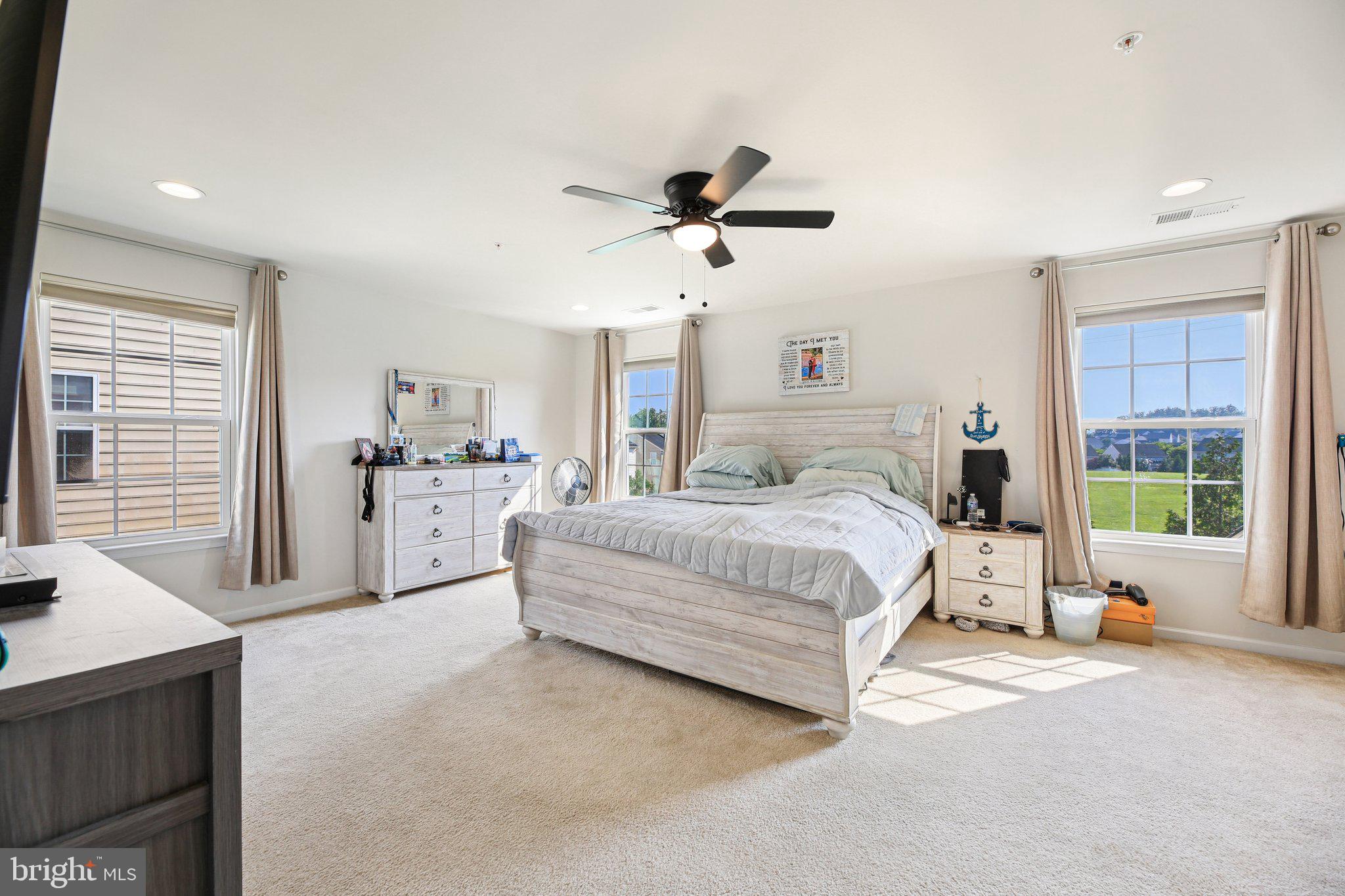 5733 Allender Road White Marsh, MD 21162 - Photo 18 of 47 a spacious bedroom with a bed a dresser and a window