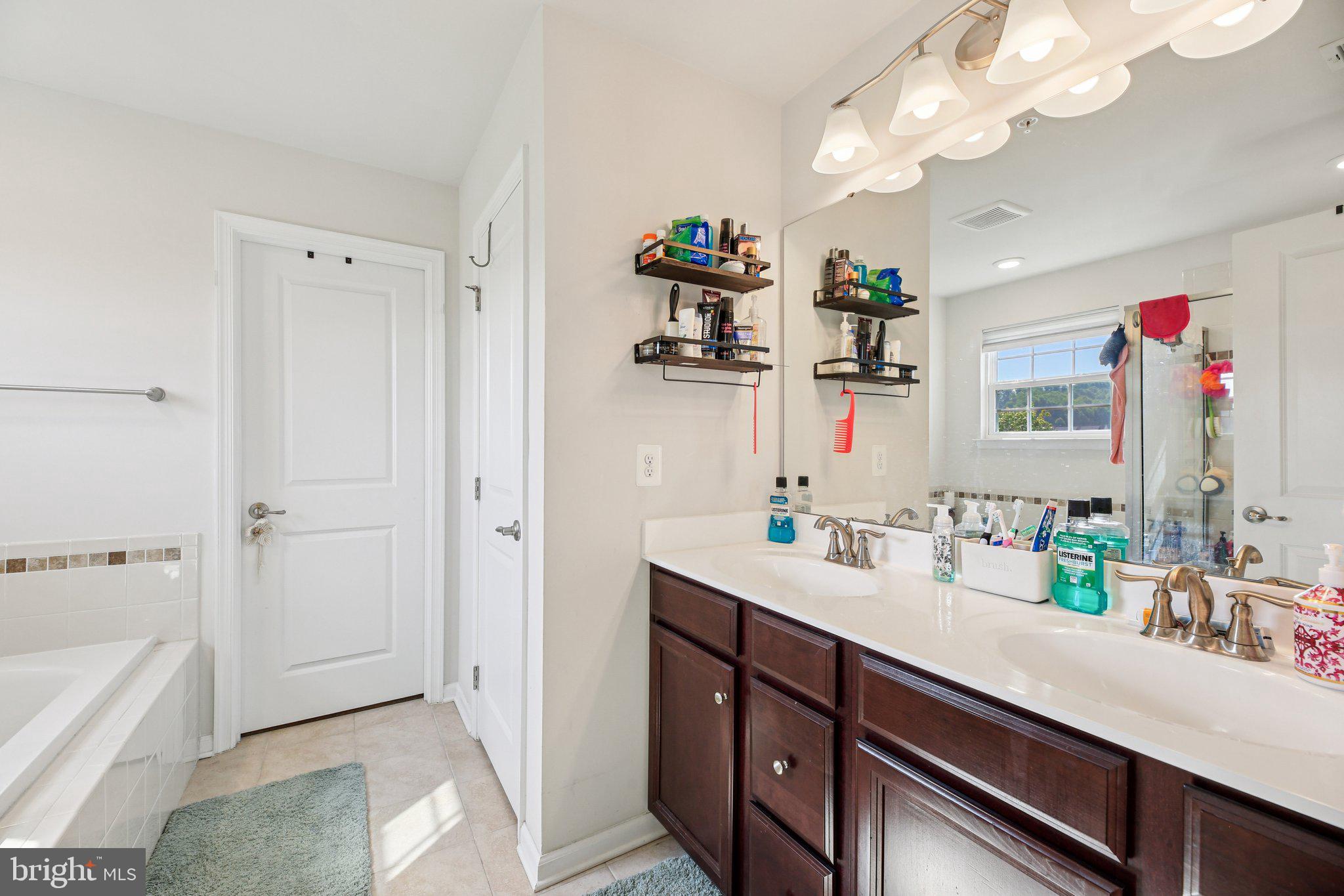 5733 Allender Road White Marsh, MD 21162 - Photo 20 of 47 a spacious bathroom with a sink a large mirror and a bathtub