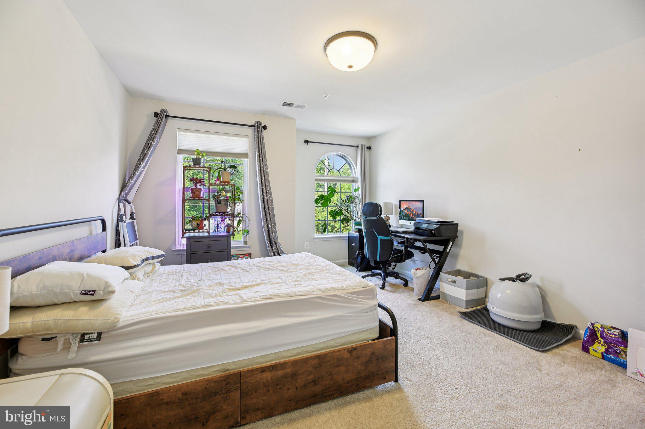 5733 Allender Road White Marsh, MD 21162 - Photo 26 of 47 a bedroom with a bed and large windows