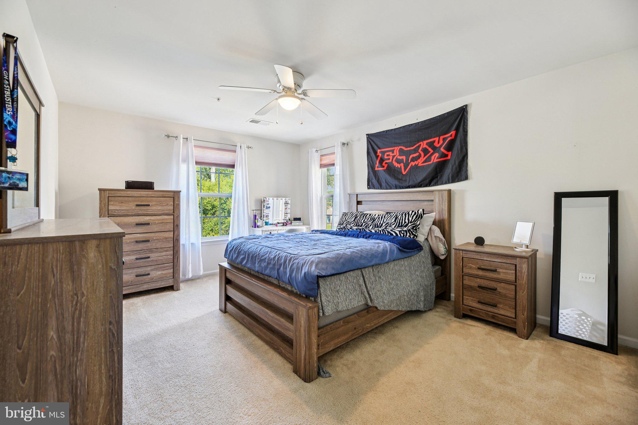 5733 Allender Road White Marsh, MD 21162 - Photo 29 of 47 a spacious bedroom with a bed and a flat screen tv