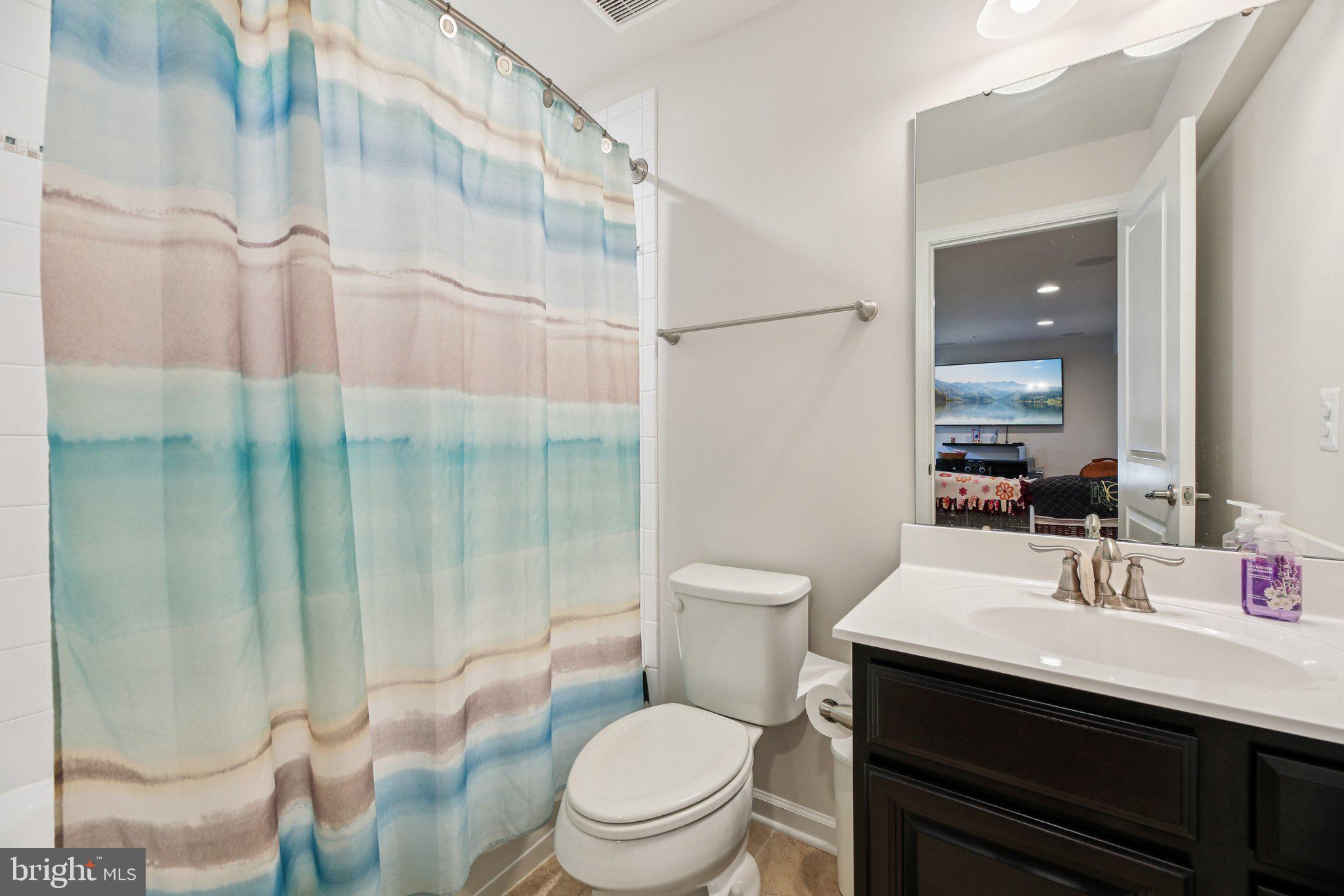 5733 Allender Road White Marsh, MD 21162 - Photo 32 of 47 a bathroom with a sink toilet vanity and shower