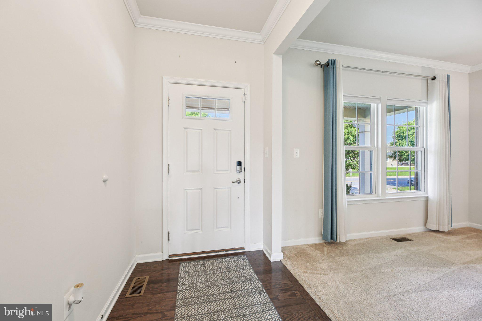 5733 Allender Road White Marsh, MD 21162 - Photo 6 of 47 a view of a hallway with wooden floor and a bathroom
