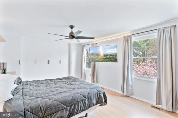 a spacious bedroom with a bed and a desk