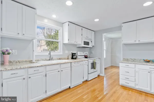 a kitchen with sink cabinets and window