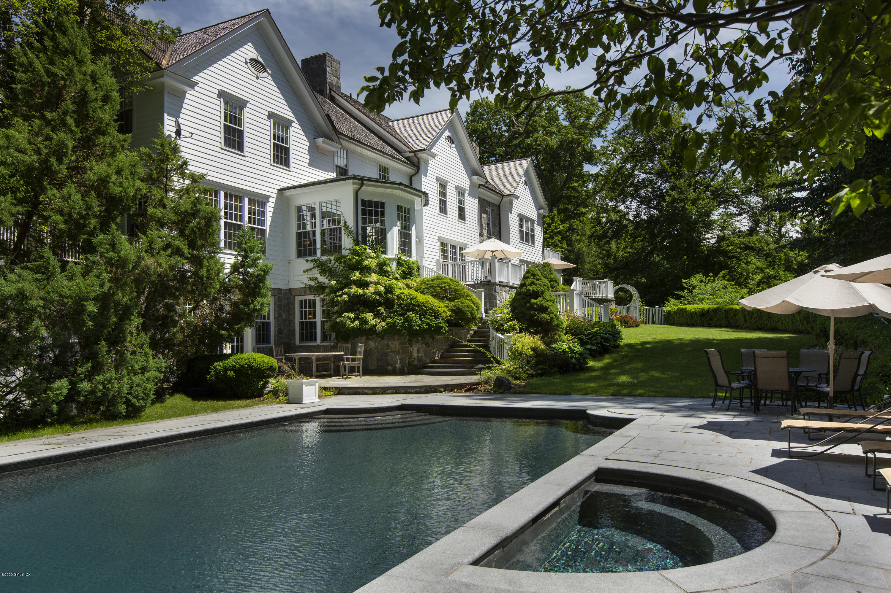 69 Porchuck Road Greenwich, CT 06831 - Photo 18 of 21 a view of a house with pool plants and large trees
