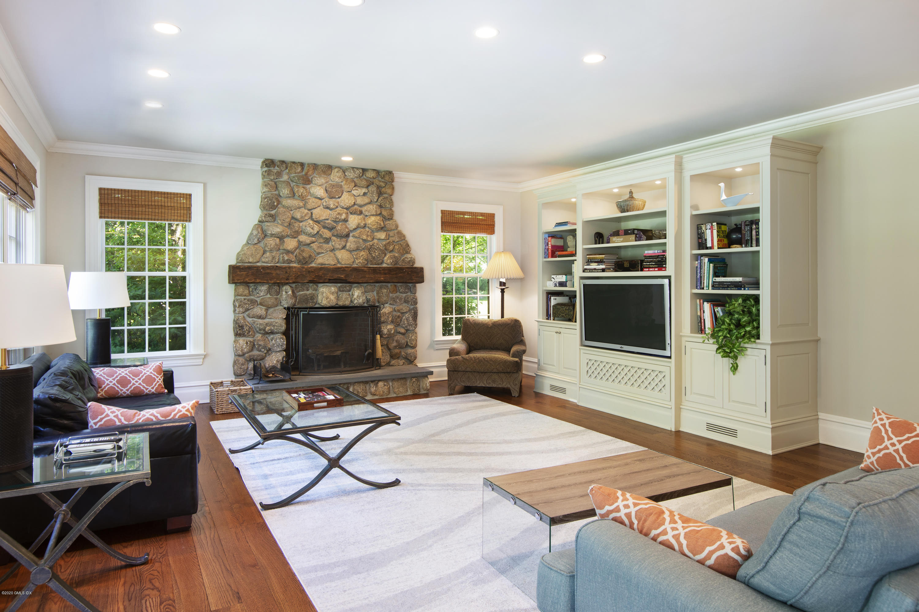 69 Porchuck Road Greenwich, CT 06831 - Photo 8 of 21 a living room with furniture a flat screen tv and a fireplace