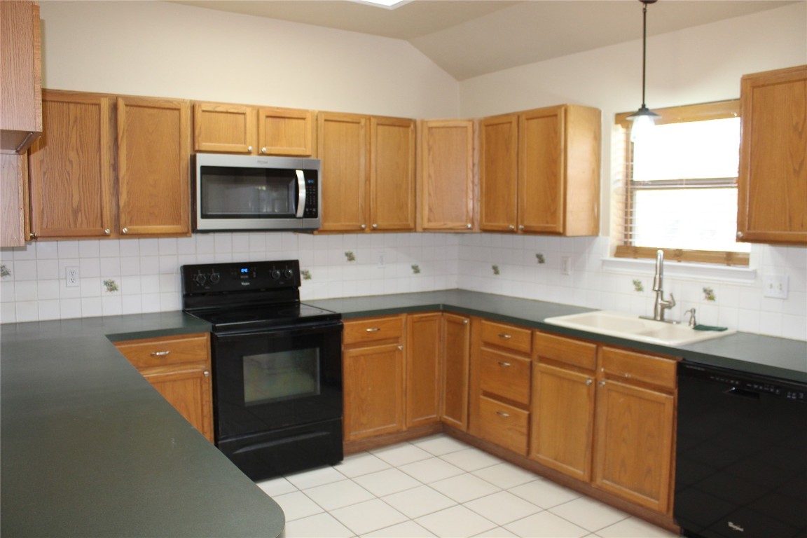 46 Crazy Cross Road Wimberley, TX 78676 - Photo 3 of 10 a kitchen with stainless steel appliances granite countertop a sink a stove a microwave a counter top space and cabinets