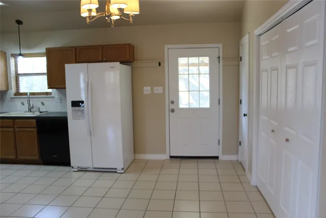 a kitchen with a refrigerator a sink and cabinets
