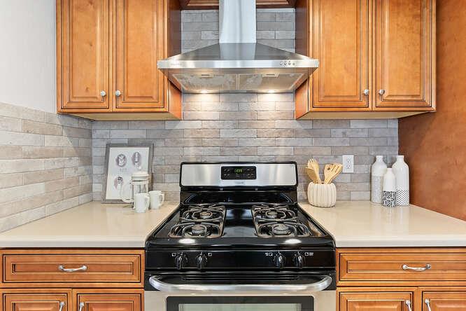 1129 Rainier Avenue Pacifica, CA 94044 - Photo 12 of 41 a stove top oven sitting inside of a kitchen