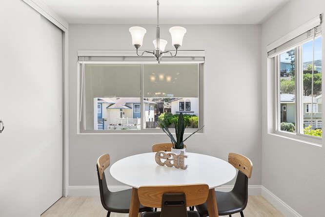 1129 Rainier Avenue Pacifica, CA 94044 - Photo 13 of 41 a view of a dining room with furniture a chandelier and wooden floor