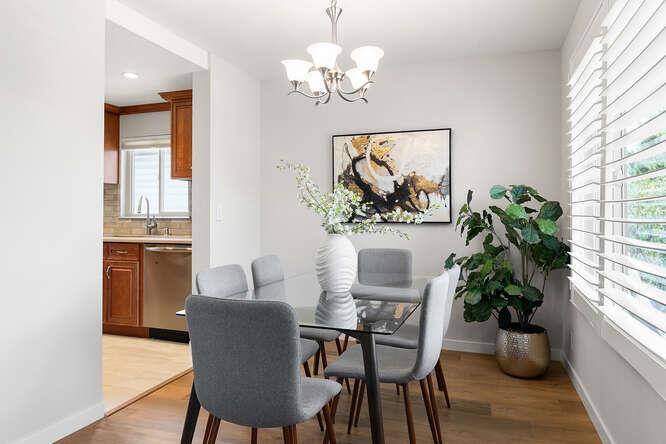 1129 Rainier Avenue Pacifica, CA 94044 - Photo 15 of 41 a dining room with furniture potted plants and wooden floor
