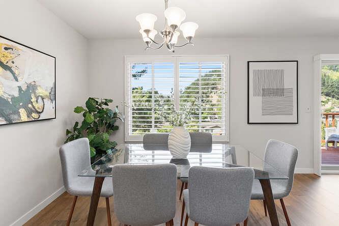 1129 Rainier Avenue Pacifica, CA 94044 - Photo 16 of 41 a dining room with furniture a large window and wooden floor