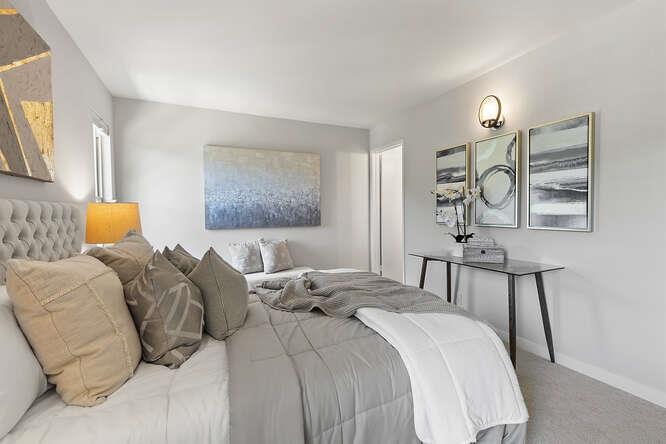 1129 Rainier Avenue Pacifica, CA 94044 - Photo 24 of 41 a bedroom with a bed a chandelier with mirror and window