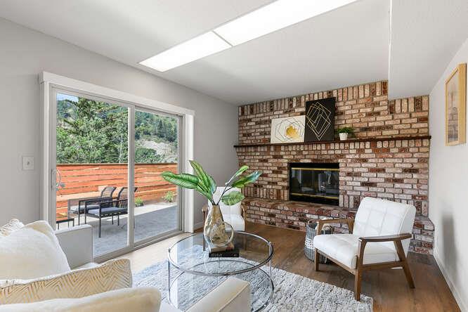 1129 Rainier Avenue Pacifica, CA 94044 - Photo 30 of 41 a living room with furniture a fireplace and a potted plant