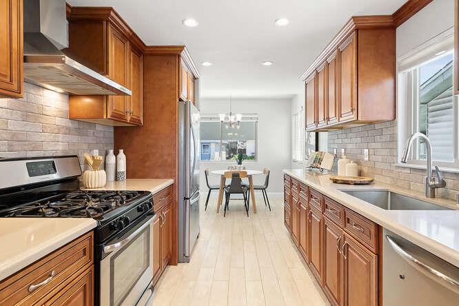 1129 Rainier Avenue Pacifica, CA 94044 - Photo 10 of 41 a kitchen with stainless steel appliances granite countertop a stove a sink and a refrigerator