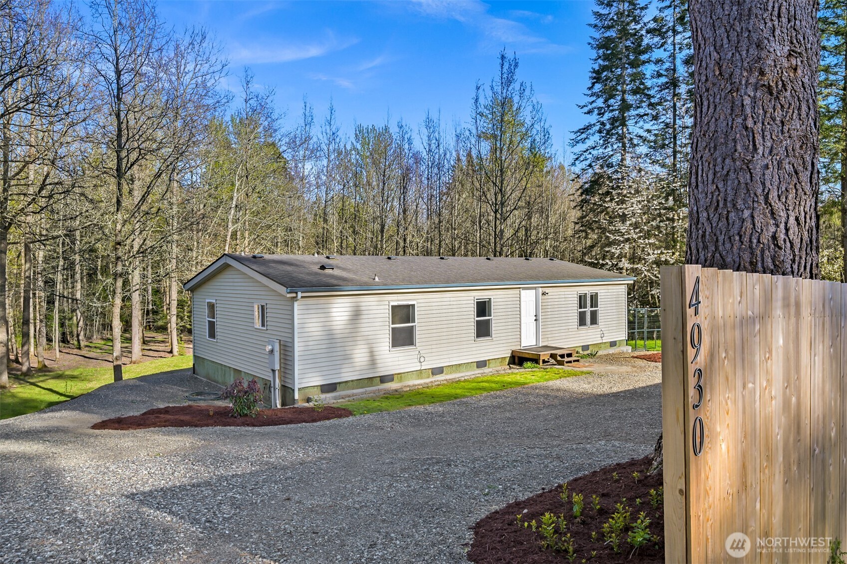 4930 Noon Road Bellingham, WA 98226 - Photo 3 of 27 a view of a house with a big yard and large trees