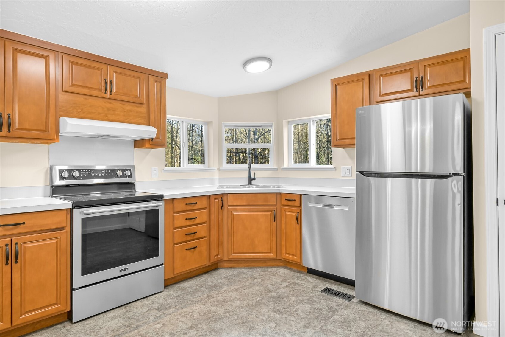 4930 Noon Road Bellingham, WA 98226 - Photo 9 of 27 a kitchen with stainless steel appliances granite countertop a refrigerator sink and stove top oven