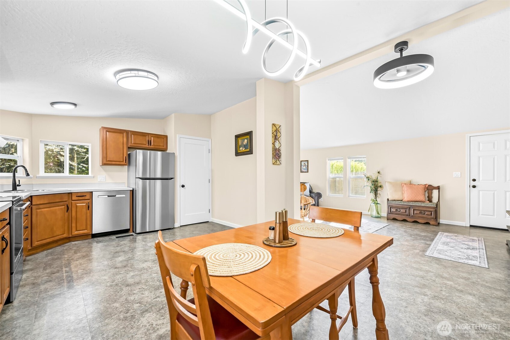 4930 Noon Road Bellingham, WA 98226 - Photo 10 of 27 a dining room with stainless steel appliances a table and chairs with kitchen view