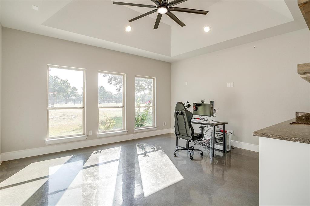 3207 Hummingbird Court Granbury, TX 76049 - Photo 13 of 40 a view of a workspace with furniture and a window