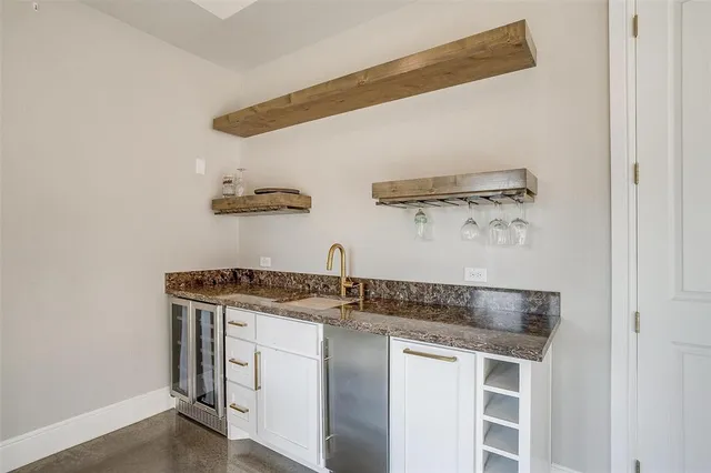 a kitchen with stainless steel appliances granite countertop a sink and a stove