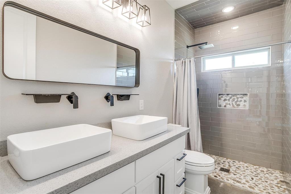 3207 Hummingbird Court Granbury, TX 76049 - Photo 24 of 40 a bathroom with a sink a toilet and shower