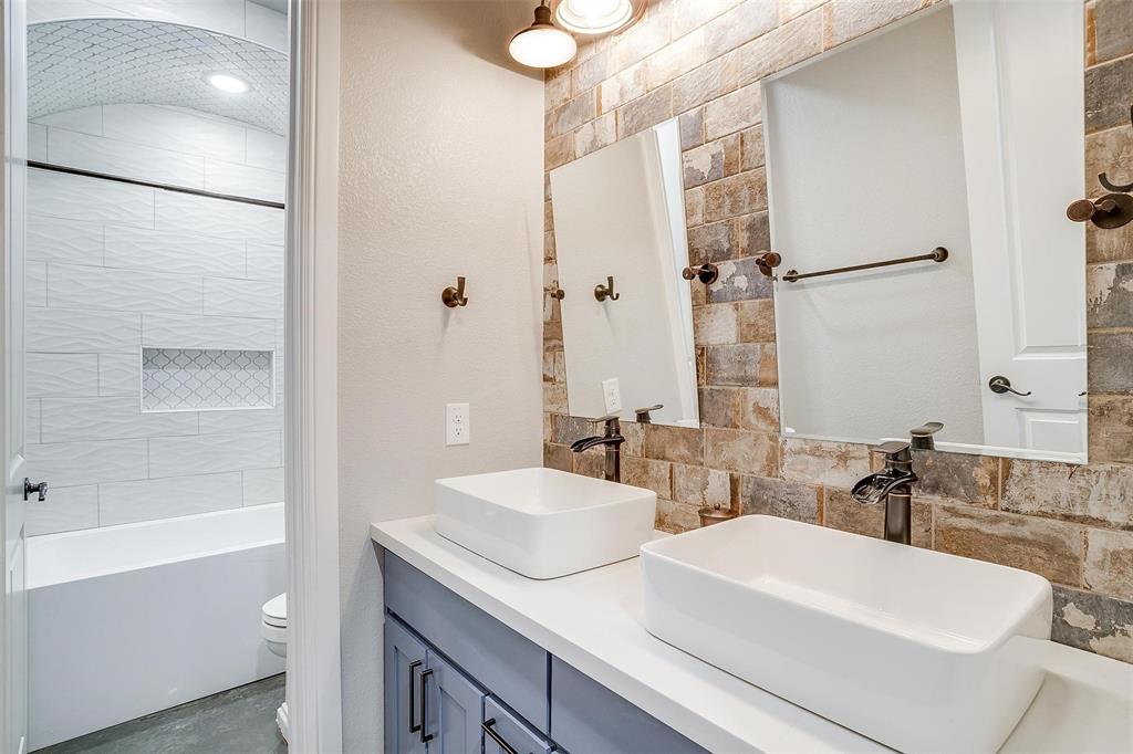3207 Hummingbird Court Granbury, TX 76049 - Photo 26 of 40 a bathroom with a sink and a mirror