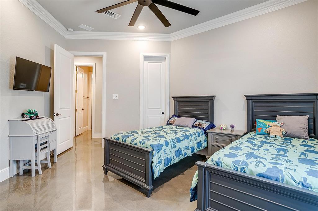 3207 Hummingbird Court Granbury, TX 76049 - Photo 27 of 40 a bedroom with two beds and a flat screen tv