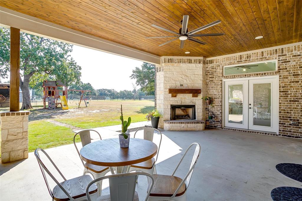 3207 Hummingbird Court Granbury, TX 76049 - Photo 35 of 40 a dining room with furniture and a fireplace