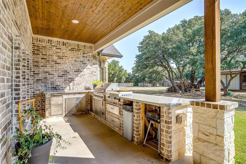 3207 Hummingbird Court Granbury, TX 76049 - Photo 36 of 40 a view of a kitchen with a sink and dishwasher