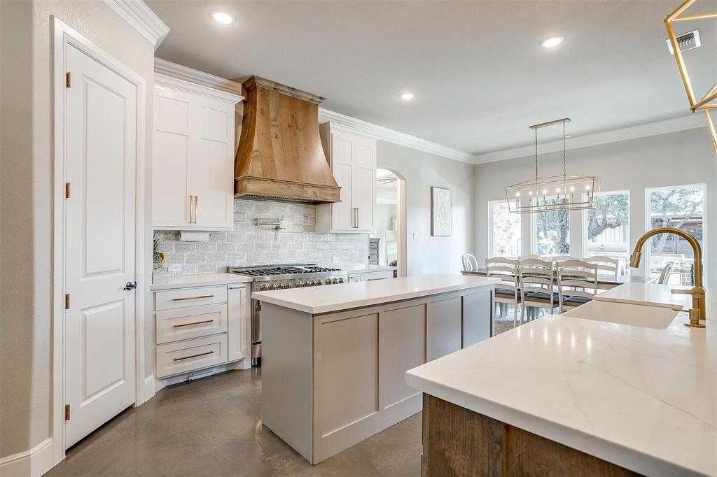 3207 Hummingbird Court Granbury, TX 76049 - Photo 6 of 40 a kitchen with white cabinets and appliances