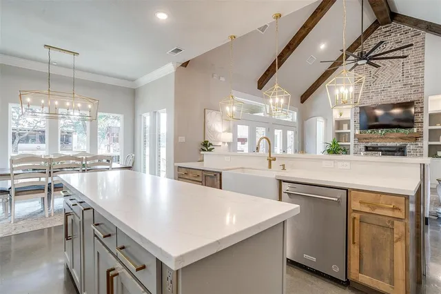 a kitchen with counter top space a sink appliances and cabinets