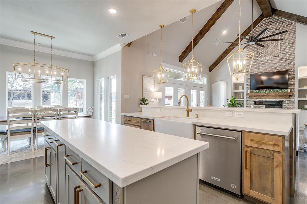 3207 Hummingbird Court Granbury, TX 76049 - Photo 8 of 40 a kitchen with counter top space a sink appliances and cabinets