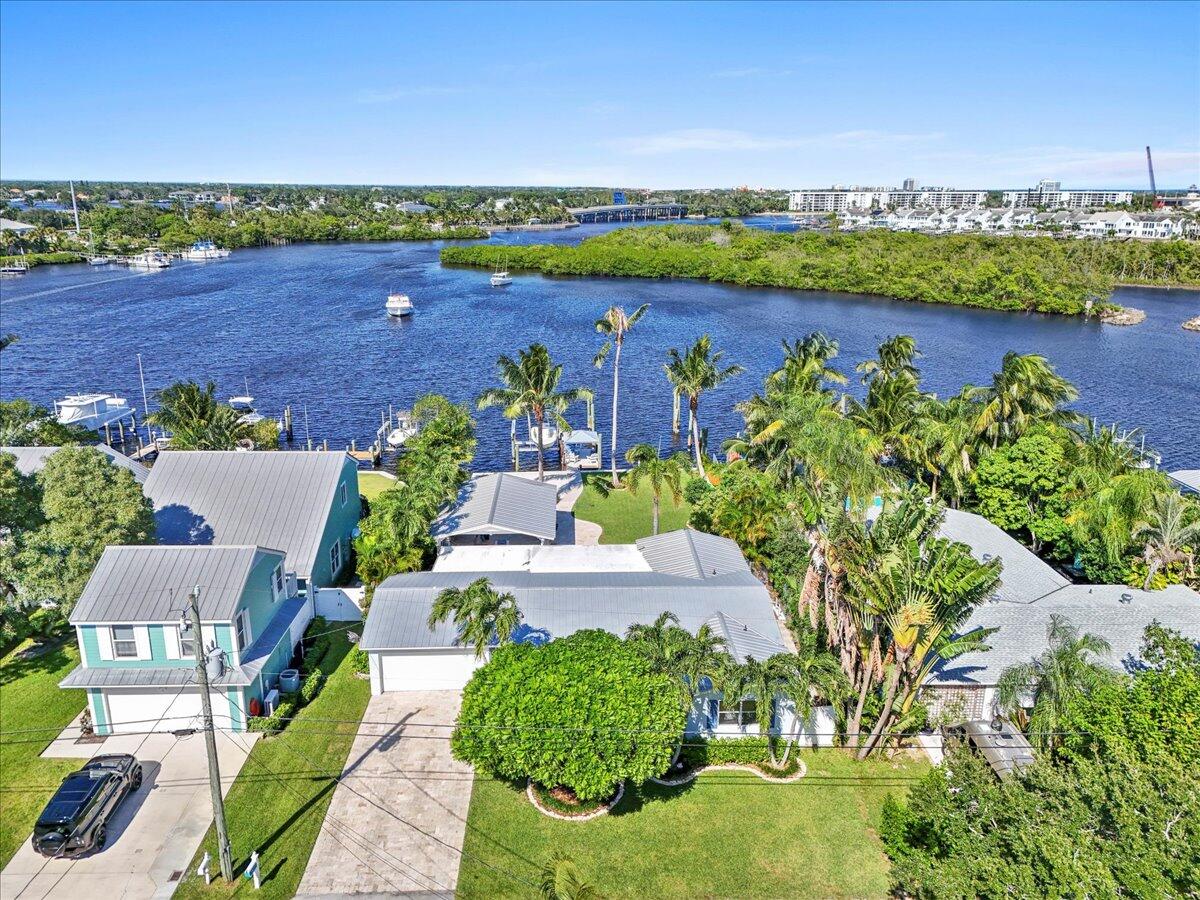 119 Elsa Road Jupiter, FL 33477 - Photo 2 of 44 an aerial view of a house with a lake view