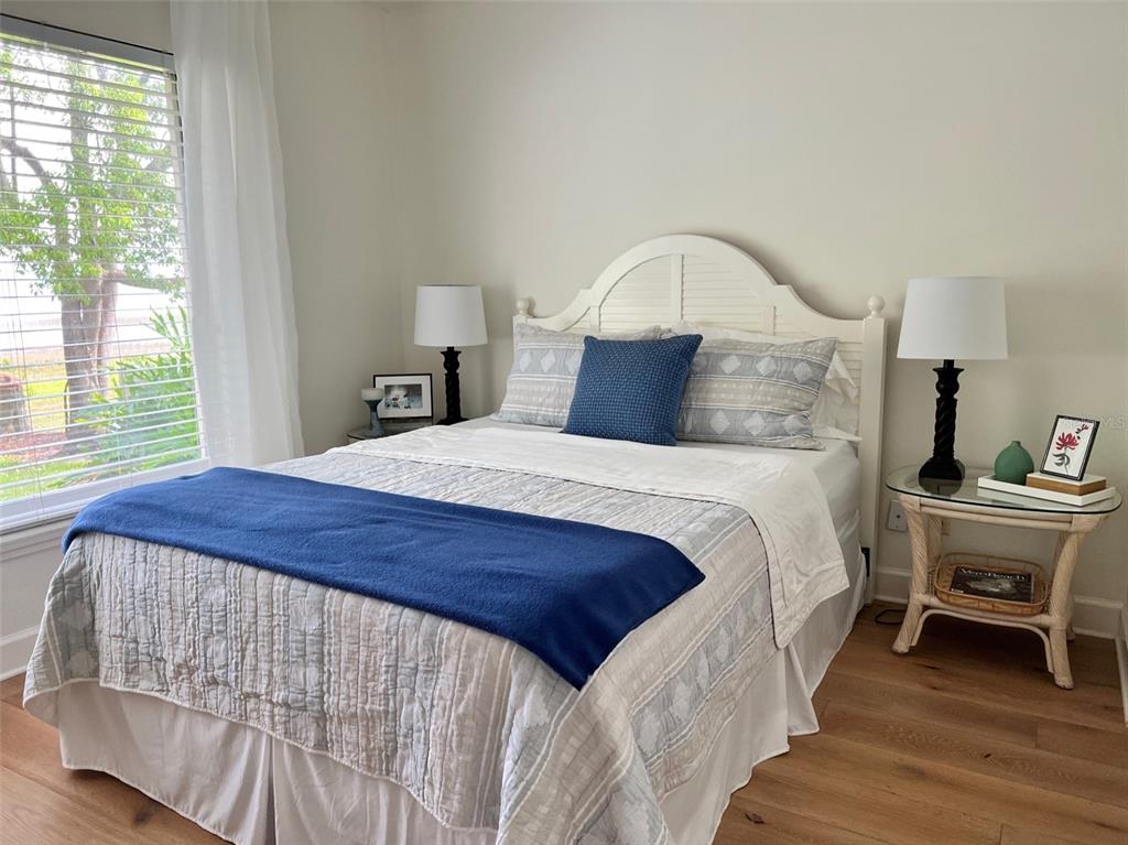12595 Southeast Sunset Harbor Road Weirsdale, FL 32195 - Photo 2 of 25 a bed sitting in a bedroom next to a window