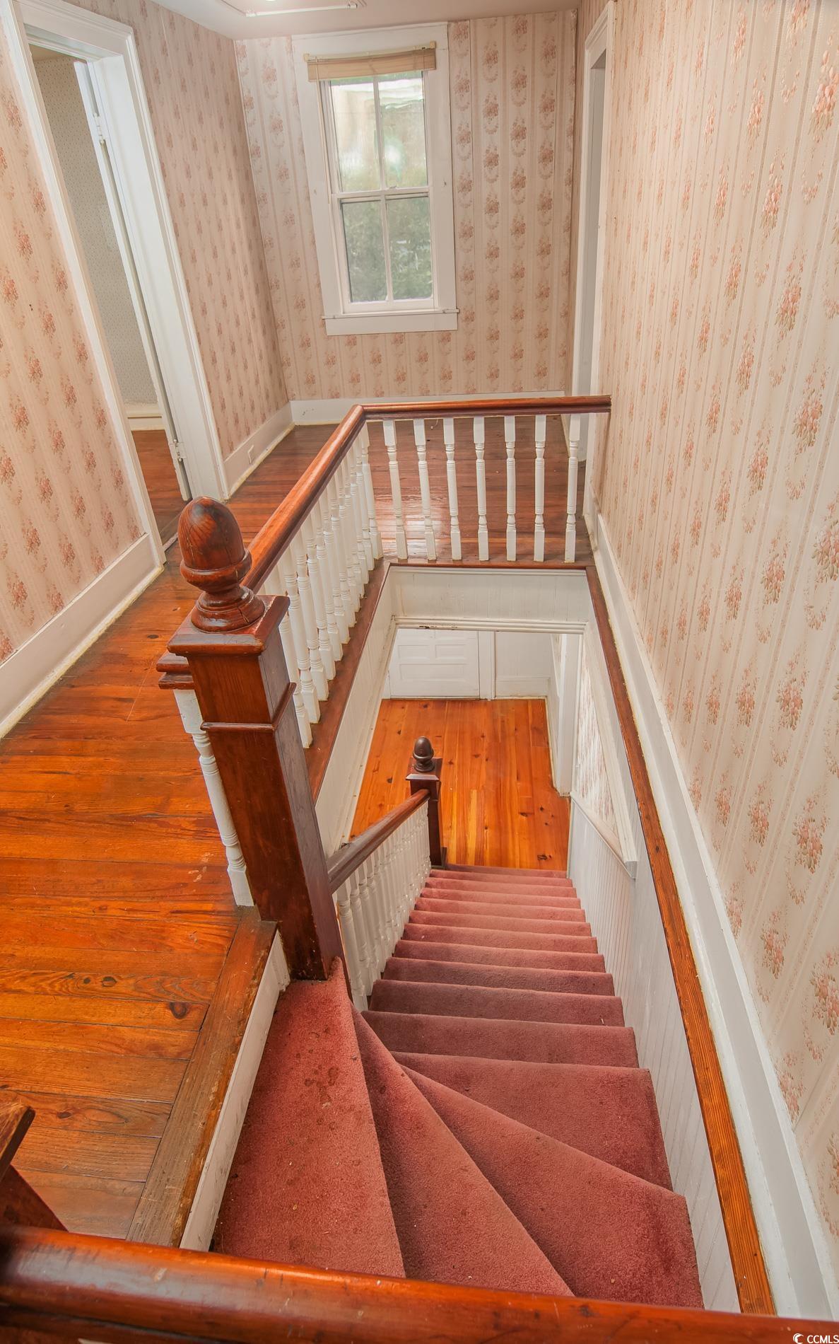 1010 Highmarket Street Georgetown, SC 29440 - Photo 18 of 32 Staircase with wallpapered walls and wood finished floors