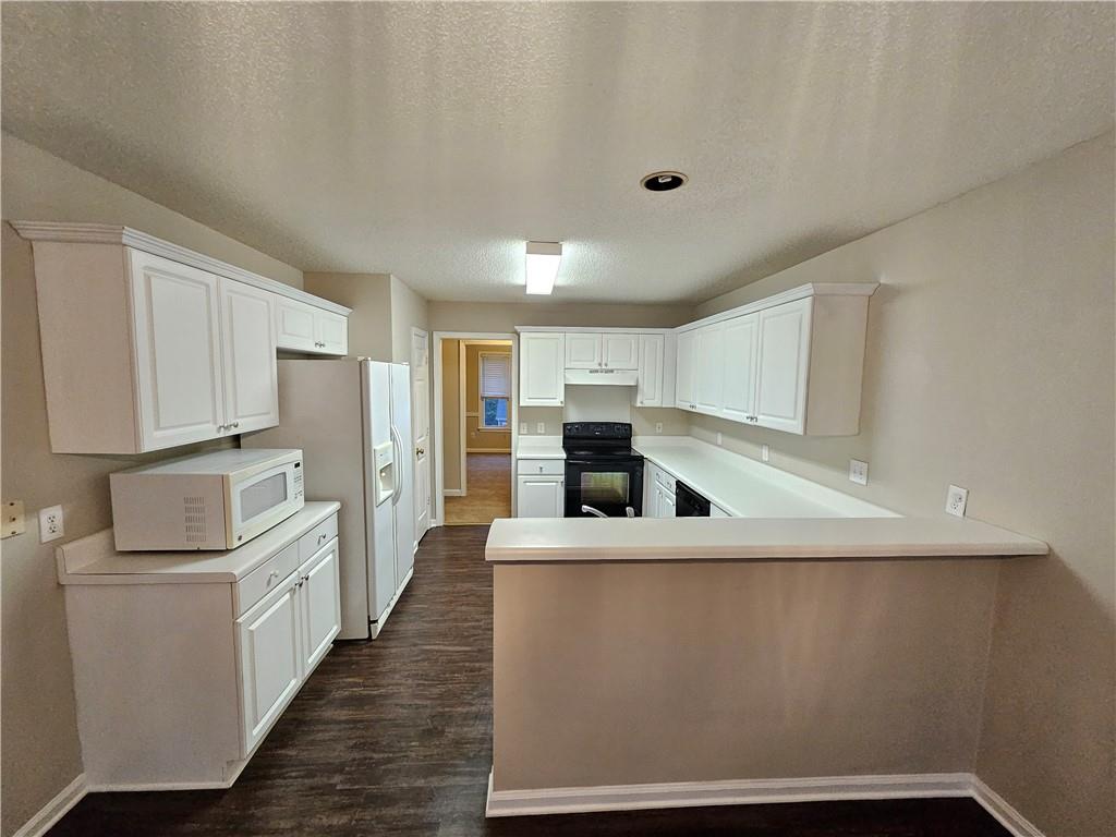 144 Hunters Trace Dallas, GA 30157 - Photo 10 of 34 a large white kitchen with stainless steel appliances