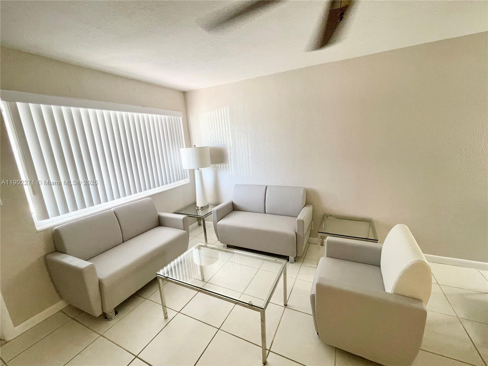 2175 Northeast 56th Street, Unit 105 Fort Lauderdale, FL 33308 - Photo 11 of 26 a living room with furniture and a couch