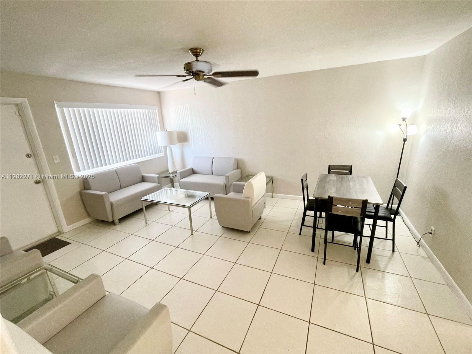 2175 Northeast 56th Street, Unit 105 Fort Lauderdale, FL 33308 - Photo 12 of 26 a living room with furniture and a rug