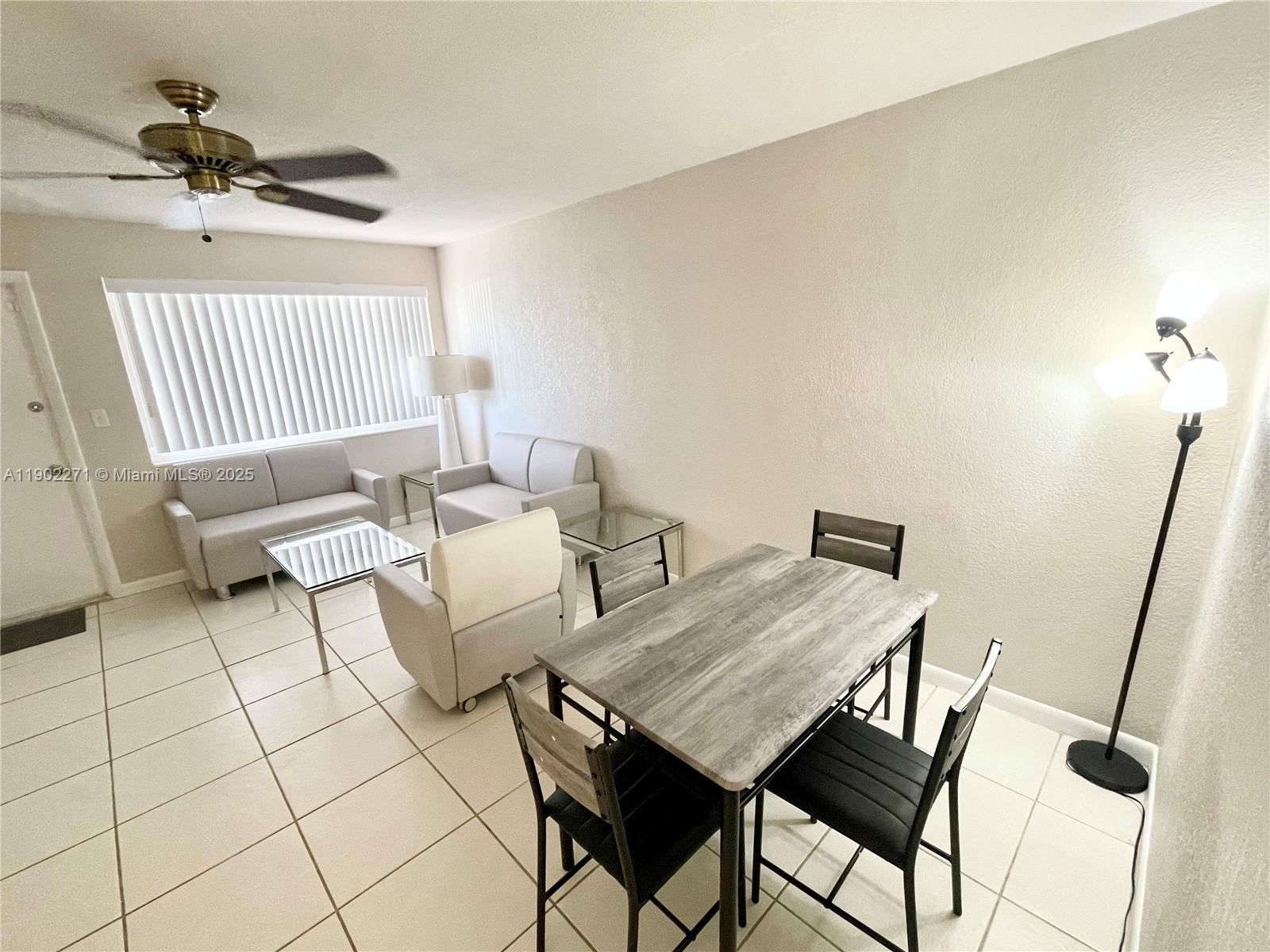2175 Northeast 56th Street, Unit 105 Fort Lauderdale, FL 33308 - Photo 13 of 26 a living room with furniture and a window