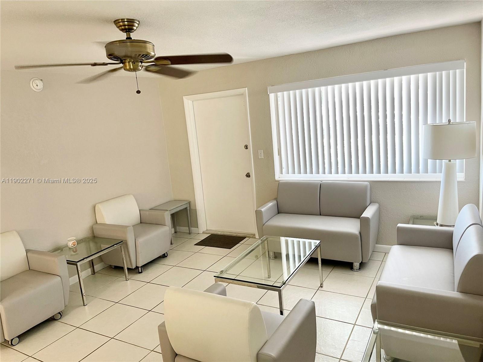 2175 Northeast 56th Street, Unit 105 Fort Lauderdale, FL 33308 - Photo 14 of 26 a living room with furniture and a window