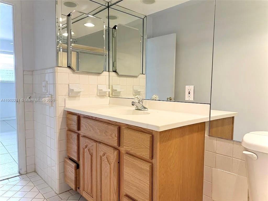 2175 Northeast 56th Street, Unit 105 Fort Lauderdale, FL 33308 - Photo 15 of 26 a bathroom with a sink and a mirror