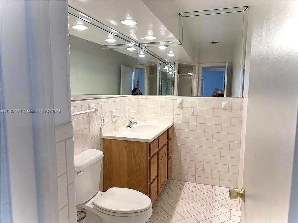 2175 Northeast 56th Street, Unit 105 Fort Lauderdale, FL 33308 - Photo 16 of 26 a bathroom with a sink a toilet and shower