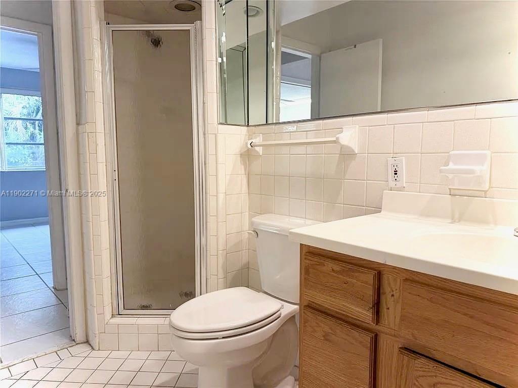 2175 Northeast 56th Street, Unit 105 Fort Lauderdale, FL 33308 - Photo 17 of 26 a bathroom with a sink a toilet and shower