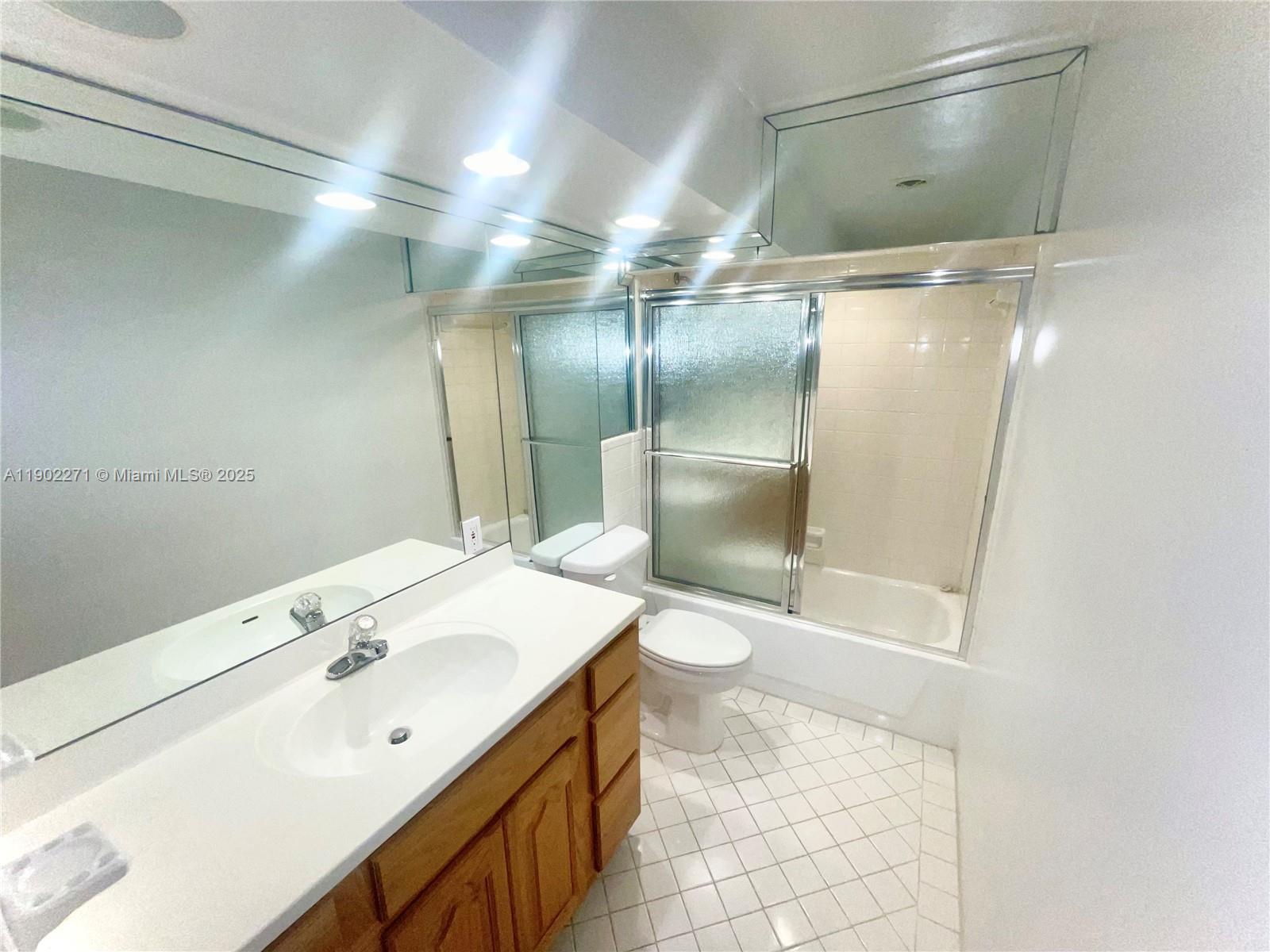 2175 Northeast 56th Street, Unit 105 Fort Lauderdale, FL 33308 - Photo 19 of 26 a bathroom with a sink and a mirror