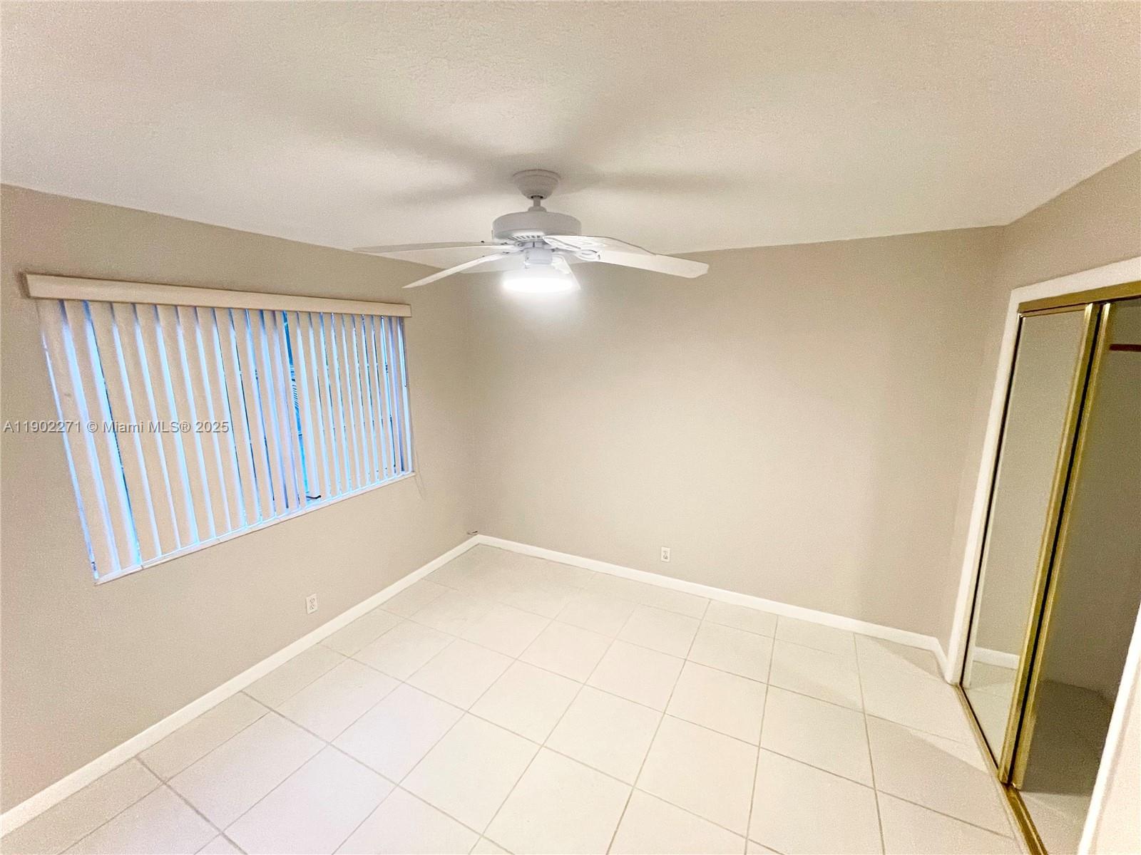 2175 Northeast 56th Street, Unit 105 Fort Lauderdale, FL 33308 - Photo 2 of 26 a view of an empty room with a window
