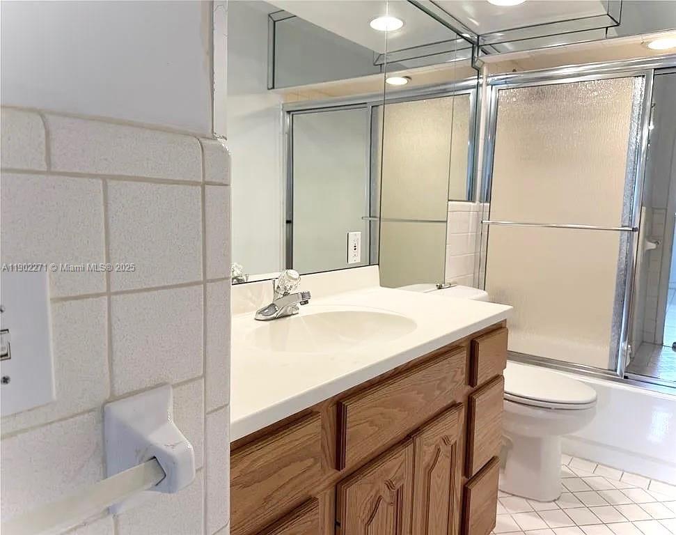 2175 Northeast 56th Street, Unit 105 Fort Lauderdale, FL 33308 - Photo 22 of 26 a bathroom with a sink toilet a mirror and shower