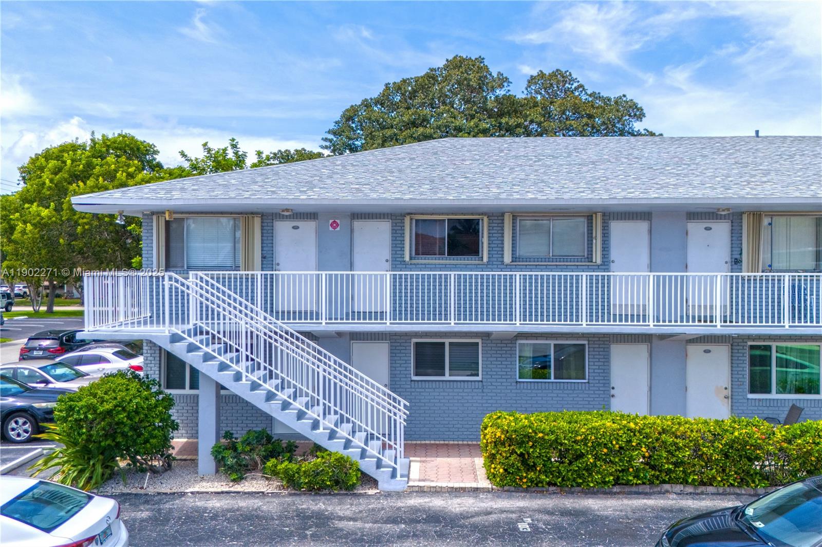 2175 Northeast 56th Street, Unit 105 Fort Lauderdale, FL 33308 - Photo 24 of 26 a front view of a house with a garden